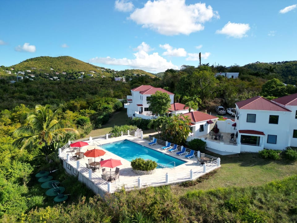Sun-soaked pool area with panoramic hillside views