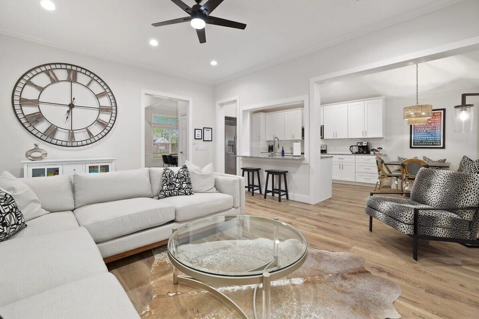 Here, you'll find a plush sectional, a 65-inch Sony Smart TV, working electric fireplace and large windows with lots of natural light.