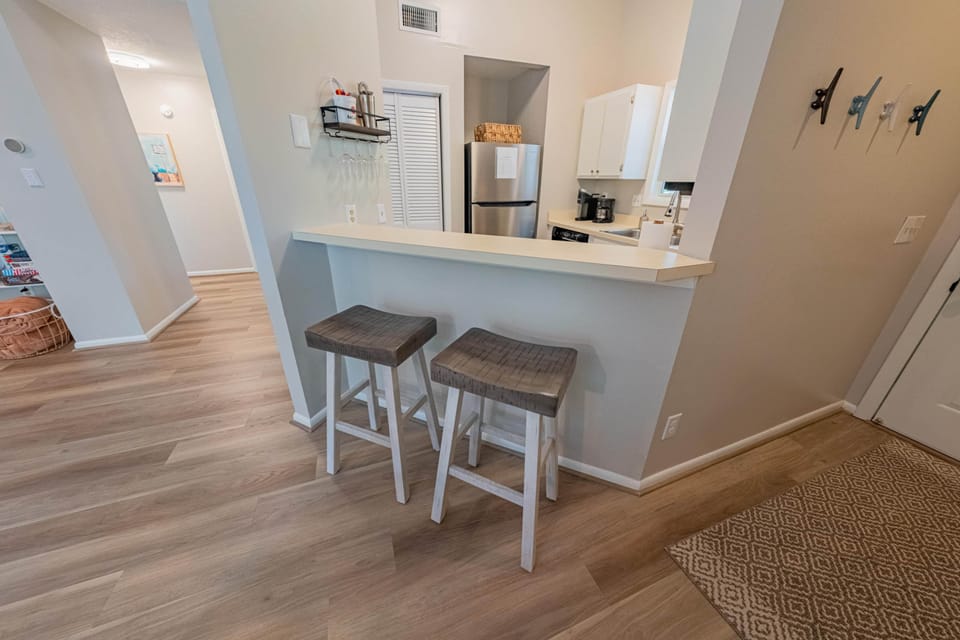 Bar seating between the dining and kitchen provides casual seating for guests' enjoyment