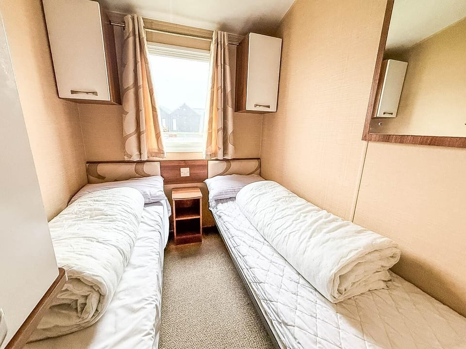 The caravan bedroom offers a cosy and comfortable space for relaxation.