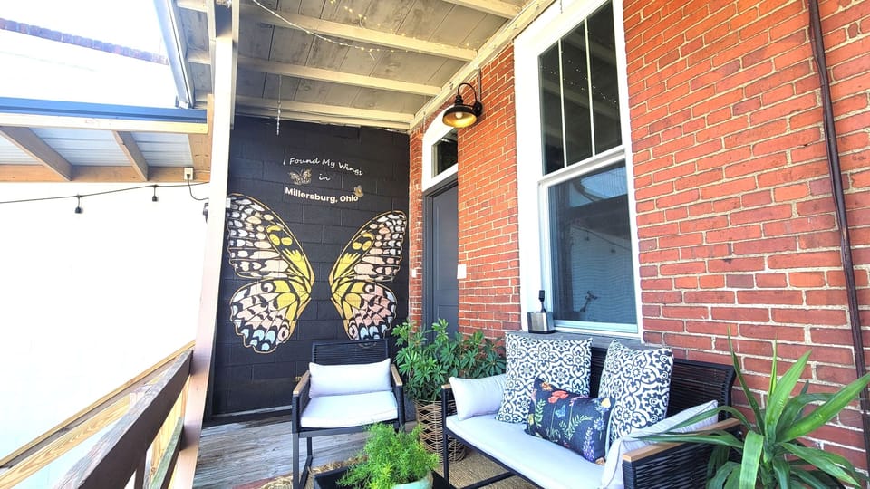 Come sit on our shabby-chic back deck complete with twinkle lights, a beautiful photo mural and a deck post for guests to sign.
