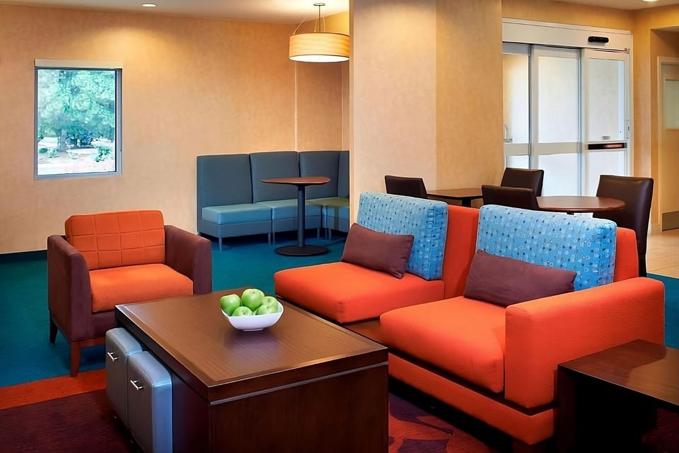 Relax in the cozy lobby with colorful seating and space.