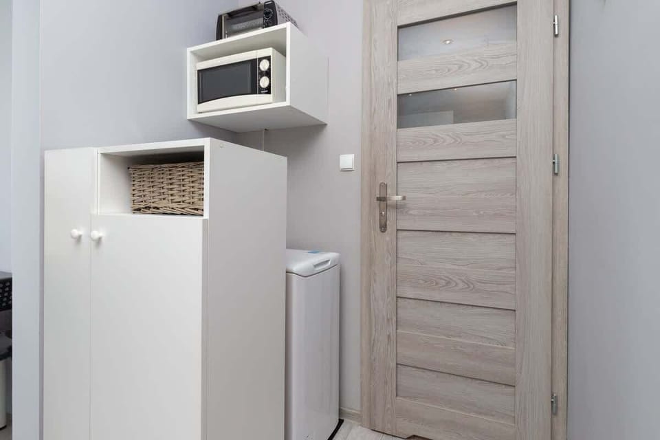 The entrance area with a sturdy wooden door and a practical layout leading to the main living space.
