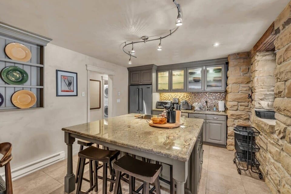 The large kitchen island makes meal prep a breeze and provides plenty of space for the whole group to be in this room together.