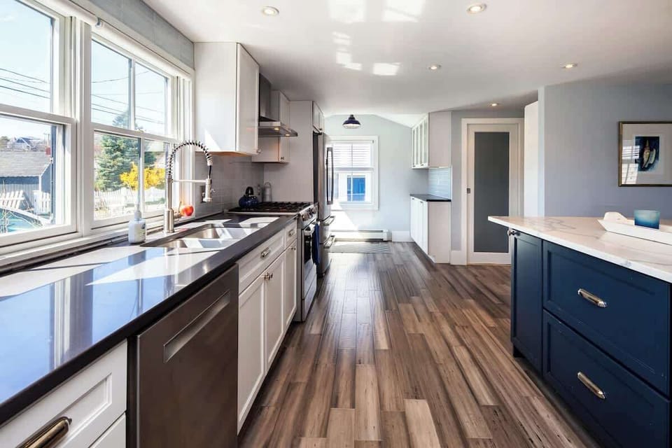 Kitchen features new stainless steel appliances including dishwasher and wine cooler 