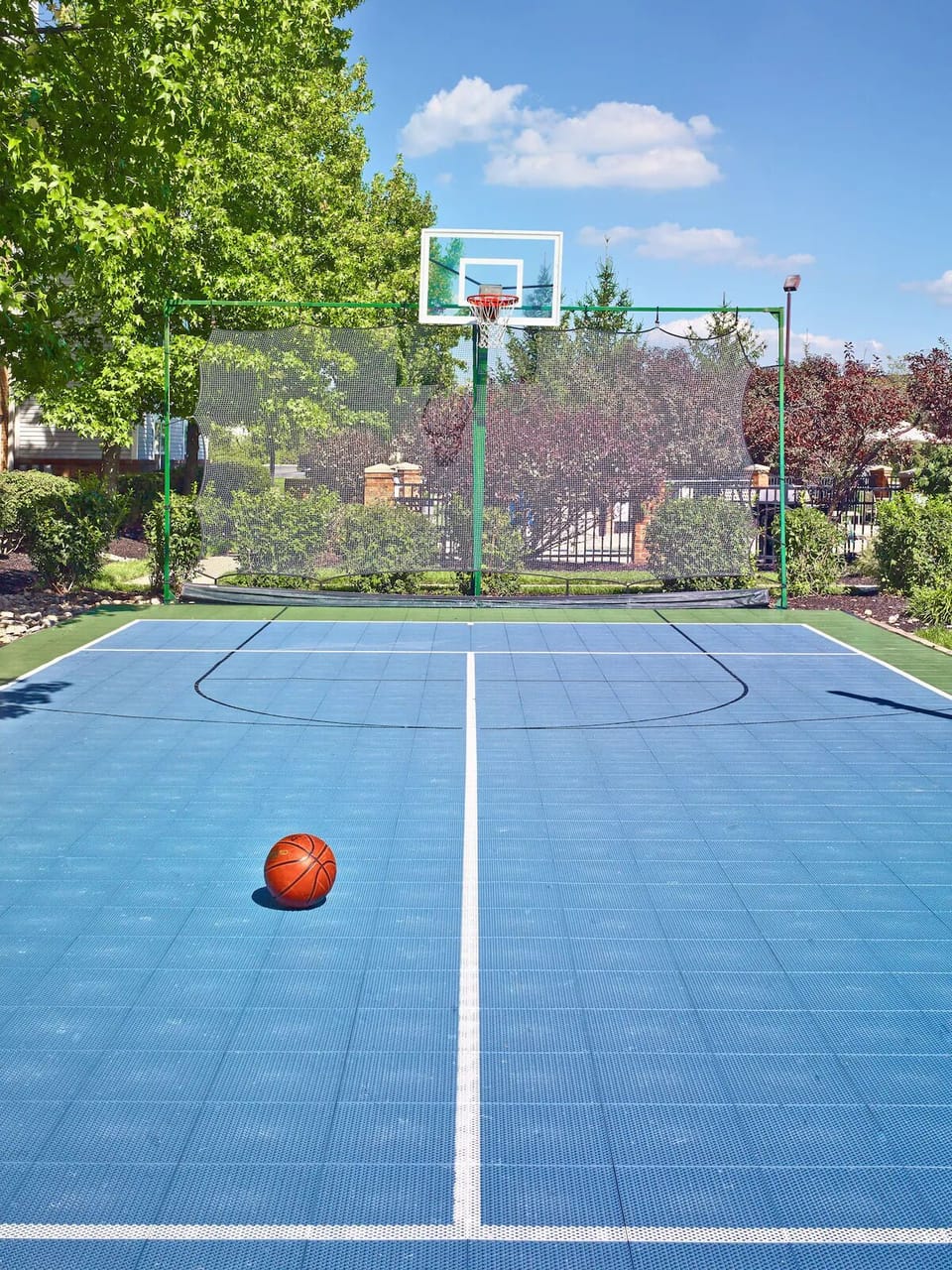 Shoot hoops together on the private outdoor sport court.