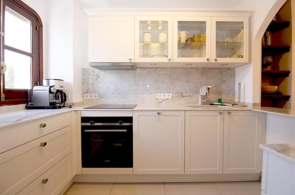 Modern and bright kitchen is fully fitted with all the appliances