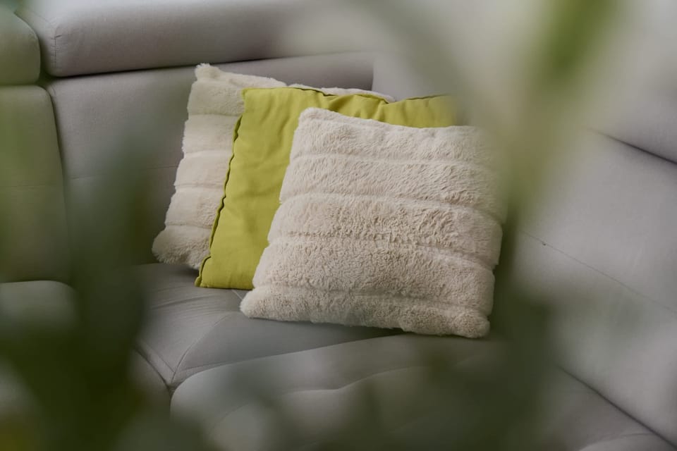 A close-up of decorative cushions on the sofa, adding texture and color.