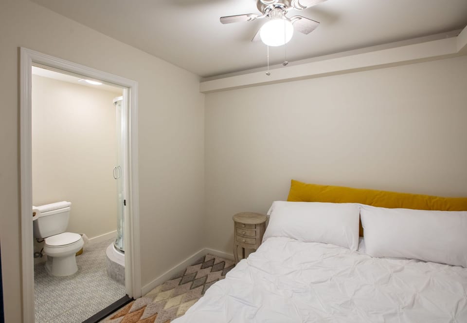 Game room bedroom w/ ensuite bathroom, separated by curtain