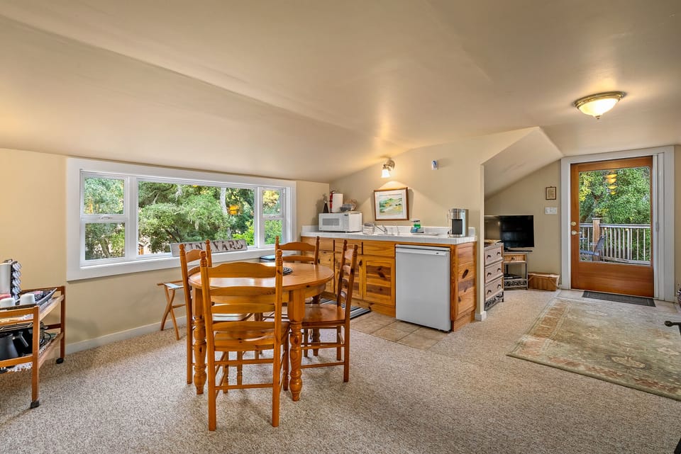 A bright kitchenette and dining area sit beside the deck