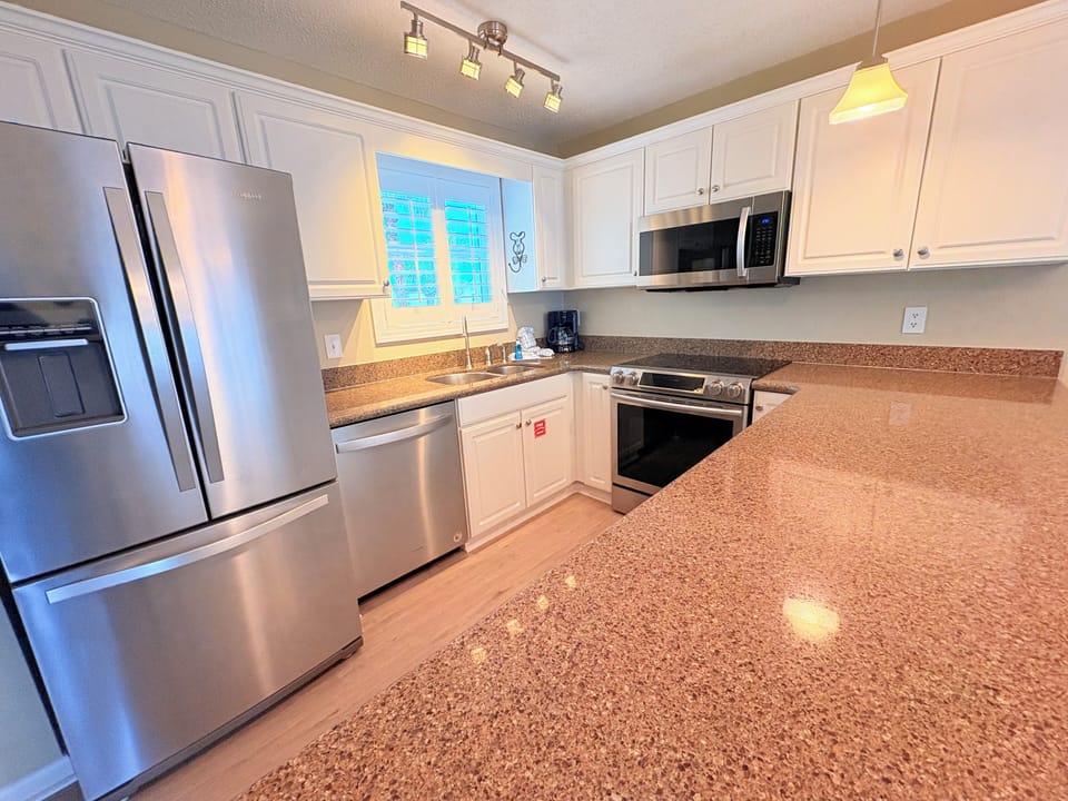 Your fully-equipped kitchen awaits with granite countertops, stainless steel appliances, and everything you need to create memorable meals together.