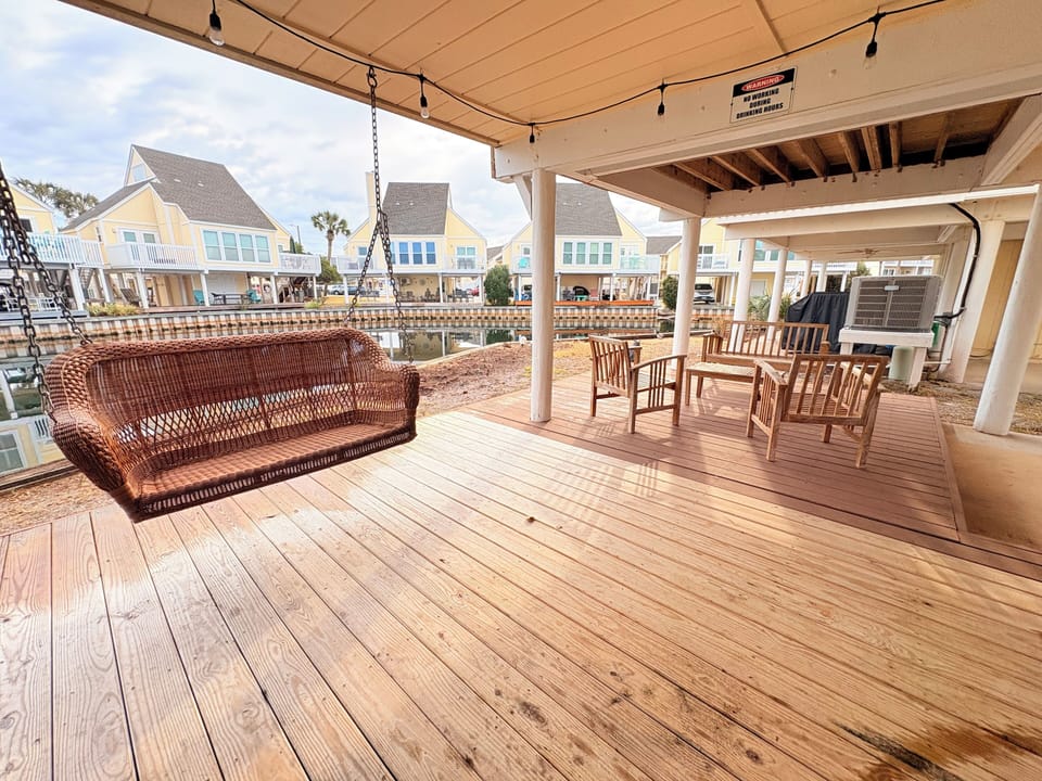Relax on your private waterfront deck with a charming swing and dining area, where coastal views and gentle breezes create the perfect retreat.