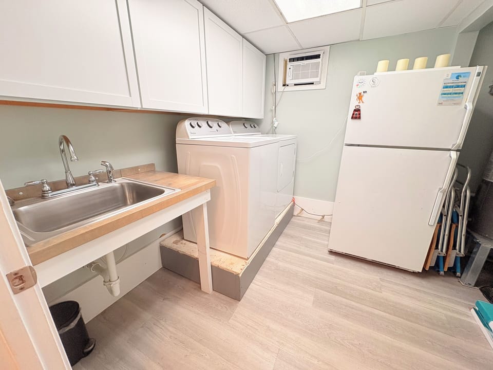 Your dedicated laundry space features modern appliances and a convenient sink for all your washing needs.