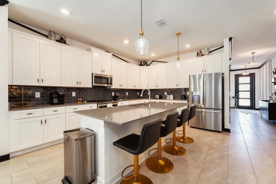 Modern kitchen with sleek design and ample seating, perfect for entertaining and family gatherings.