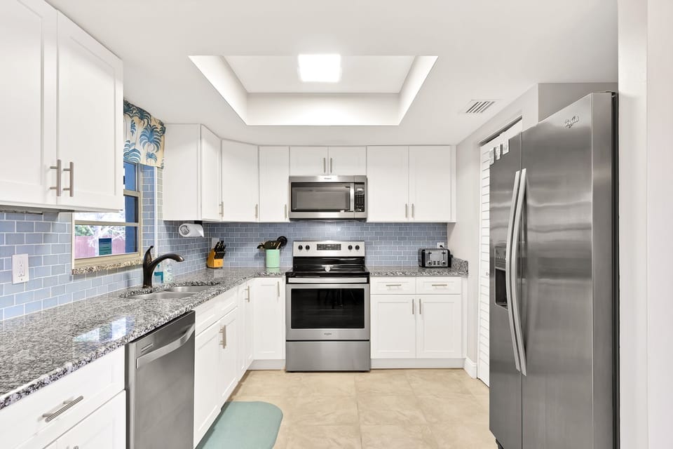 Well-stocked kitchen with many small appliances and Keurig Duo coffee maker.