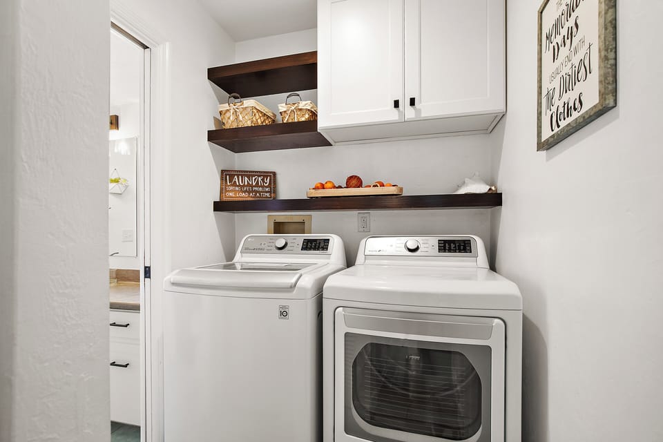 Fully equipped laundry room with provided detergent and dryer sheets.