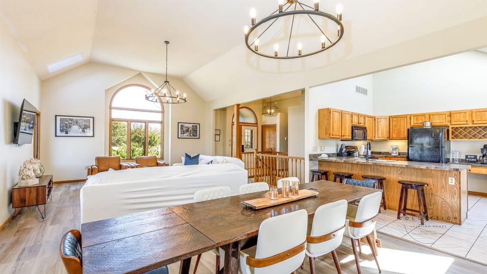 Large open concept main level. The dining table seats 8 with additional seating at the breakfast bar. 