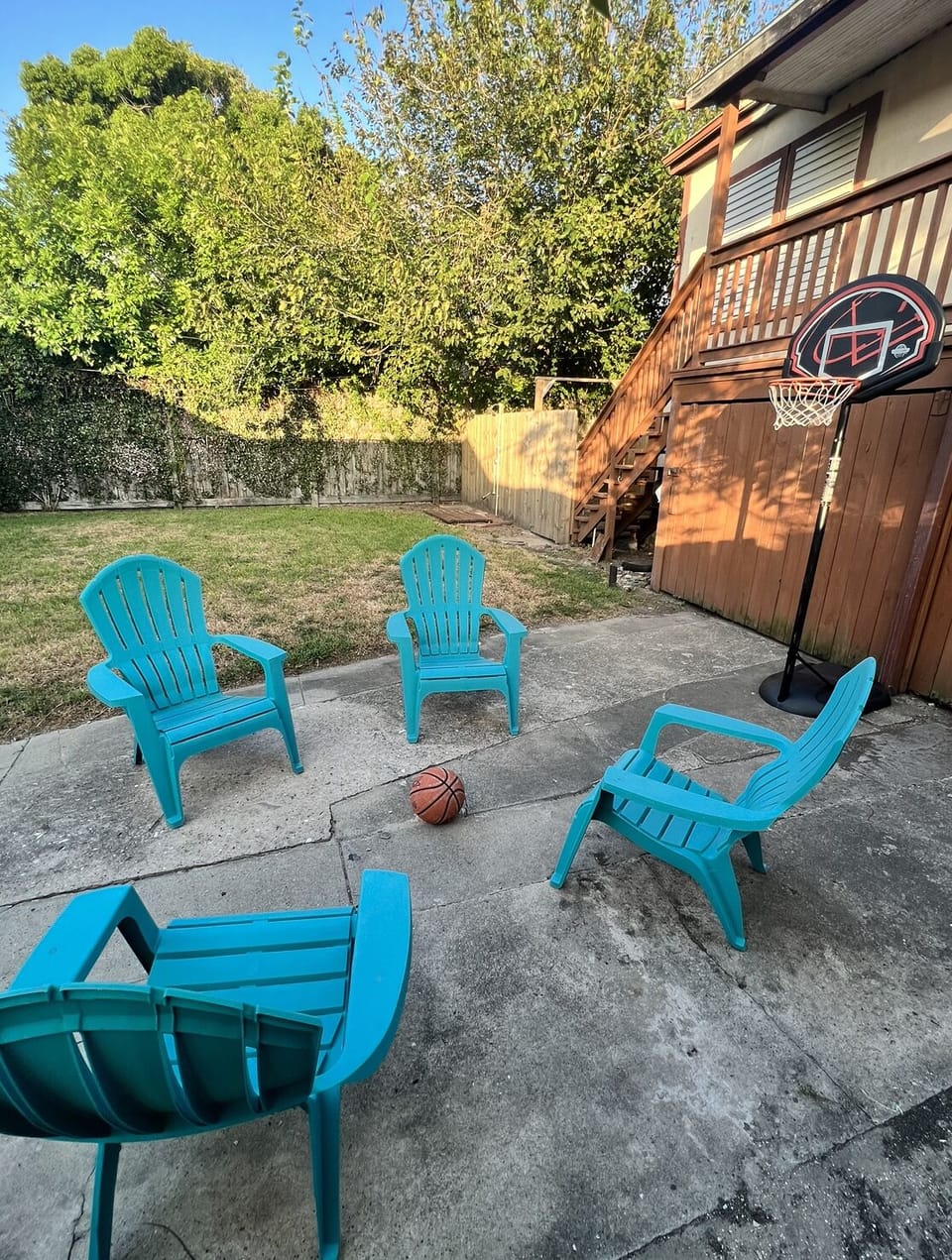 Backyard sitting area with child size basketball court