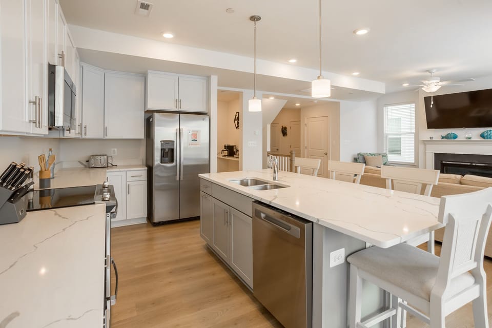 Fully stocked kitchen with high end appliance and everything you need to prepare meals at home! Kitchen Island has seating for 4