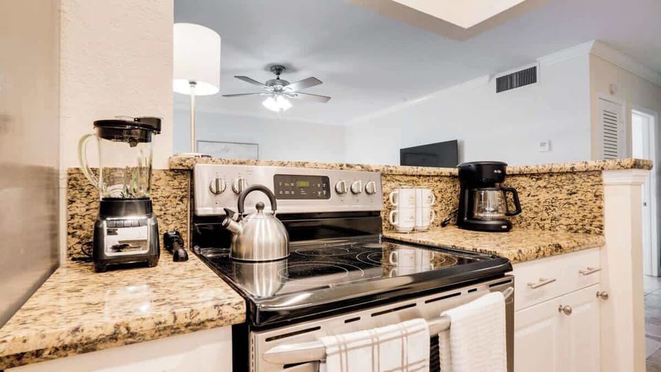 Fully stocked kitchen with complete set of cookware.