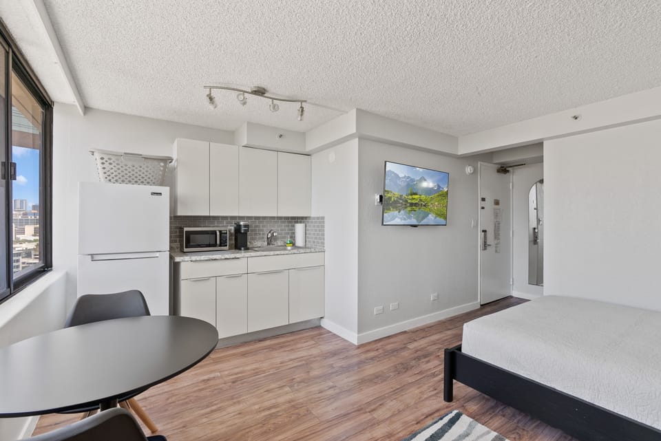 Room picture with TV, queen bed, Kitchenette, refrigerator, micr