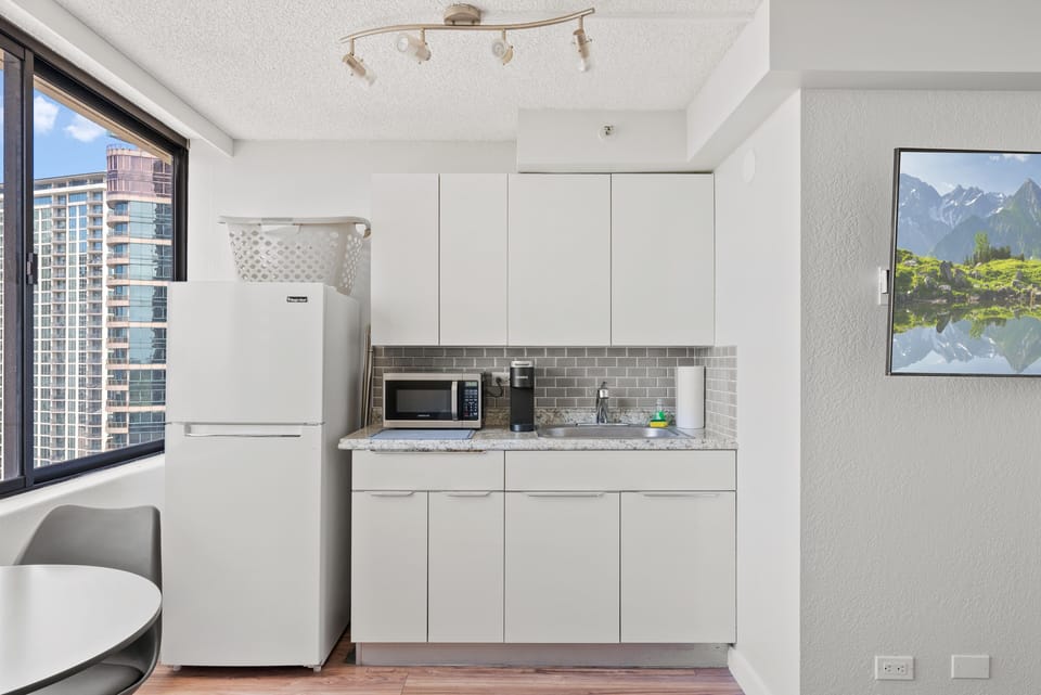Kitchenette with refrigerator, microwave, coffee maker