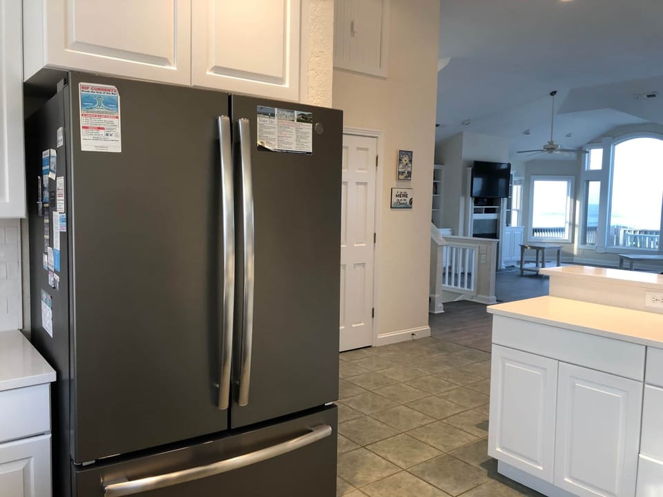 Kitchen opens to living and dining areas.