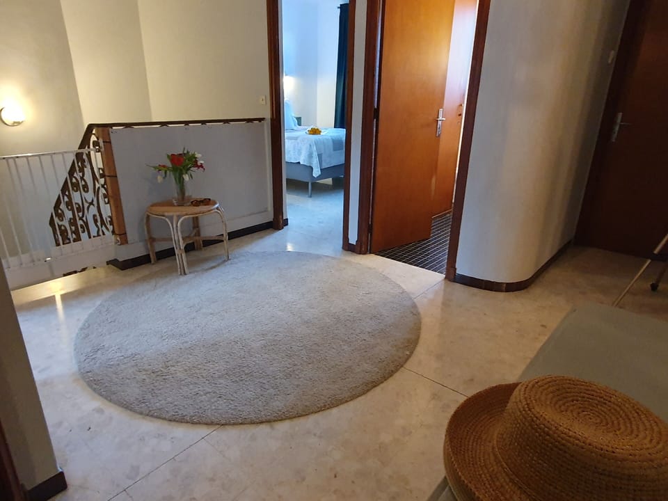 The central hallway at the top of the stairs with safety gate.