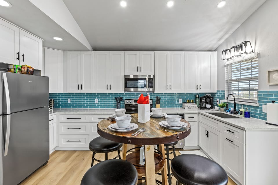 Kitchen Oasis: Bright, modern kitchen with stunning tile accents and stylish