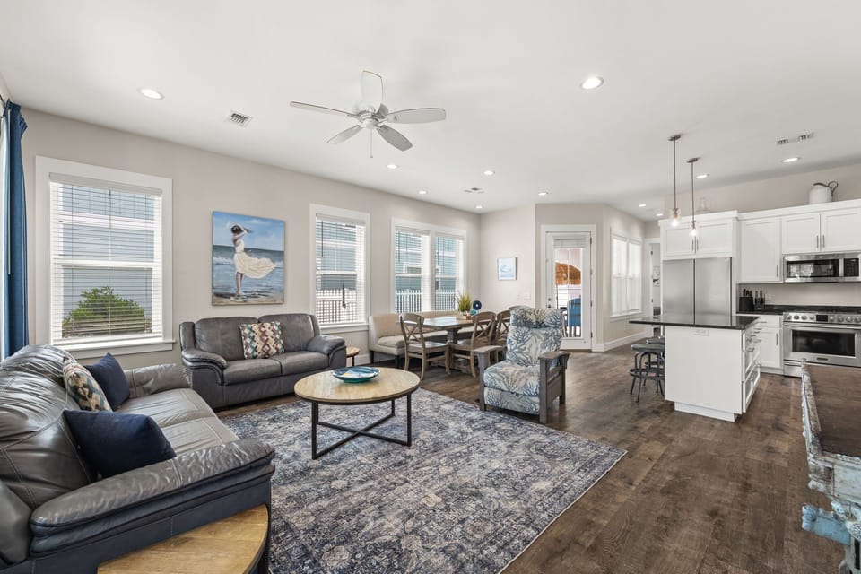 Bright coastal living room with brand-new 75” Smart TV (2026), comfortable seating & open family gathering space