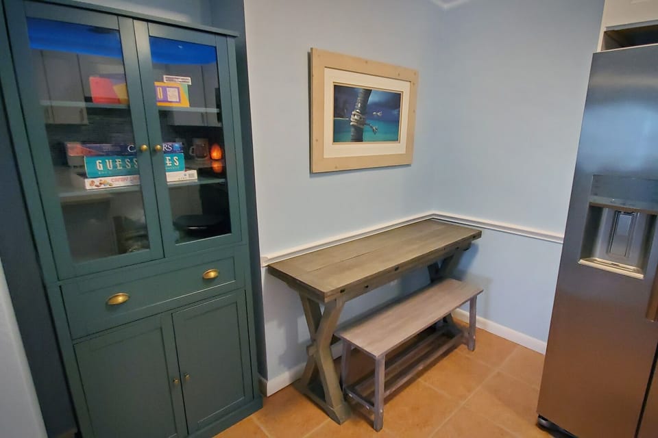 Table with fold-out top in the kitchen area for extra dining space. 