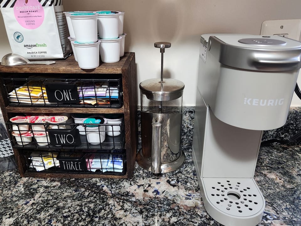 Coffee & Tea Station. We provide tea bags, ground coffee and Keurig pods, creamers, and sweeteners. There is a French press and a drip coffeemaker too.