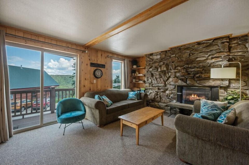 Living room with gas fireplace and private balcony