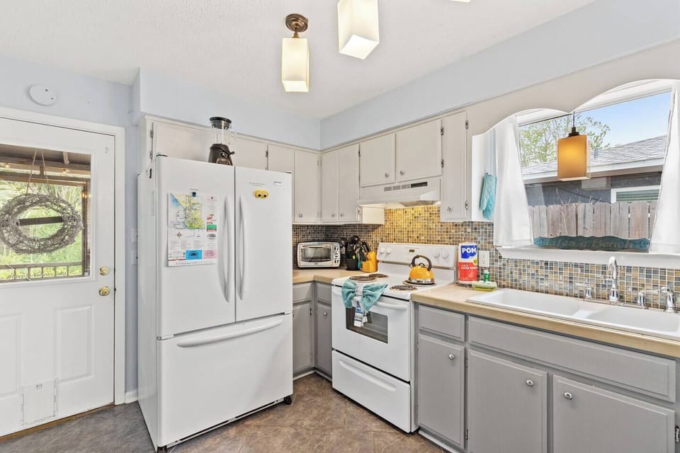 The full kitchen has a 2 kinds of coffee makers, a toaster oven, stove, microwave, large fridge, and a dishwasher.
