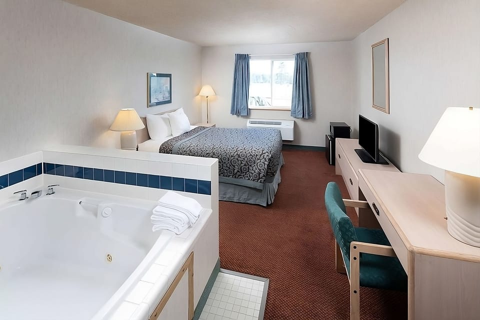 Unit a King size bed with flat screen TV and a jetted tub.