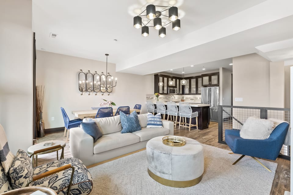 - Open living room with dining space and stylish kitchen nearby  
- Comfortable seating with modern lighting and chic design  
- Perfect gathering space for friends and family vacations