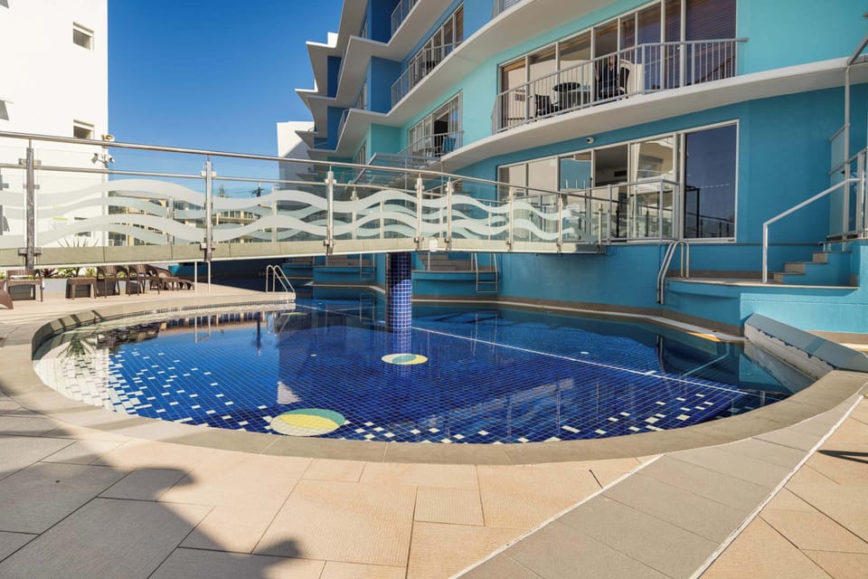 The complex has two adjoining pools, one of which is heated.