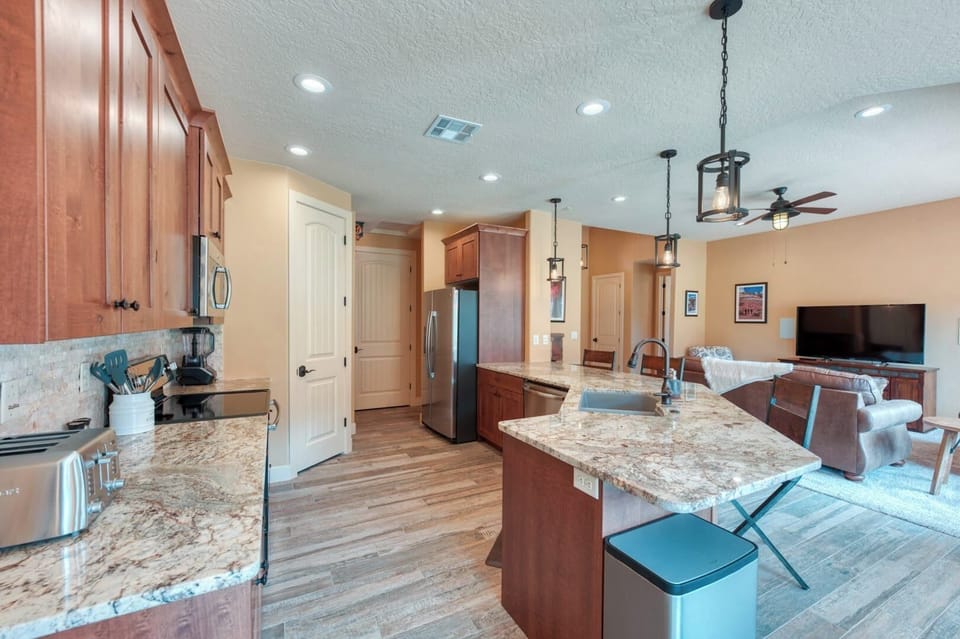 Fully equipped gourmet kitchen with granite countertops, large island, and everything needed for family meals.