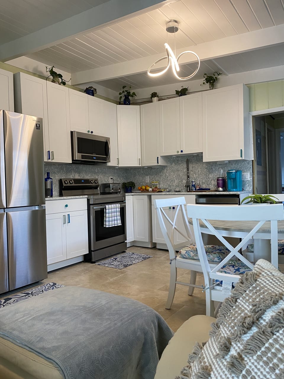 Kitchen with new Samsung stainless steel 4-door refrigerator w/ ice maker