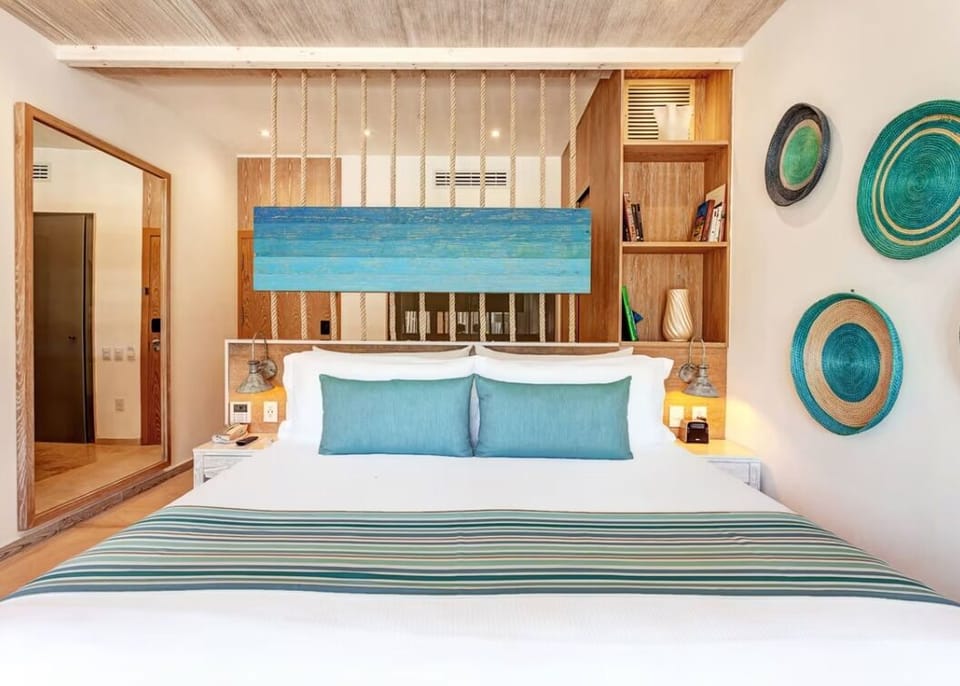 Sink into plush pillows beneath warm lighting and serene artwork.