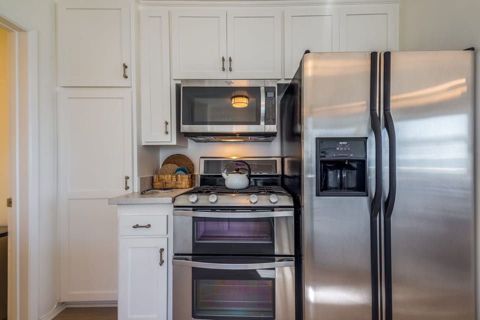 Stainless Steel Appliances. Gas Stove, Refrigerator and Microwave Oven.