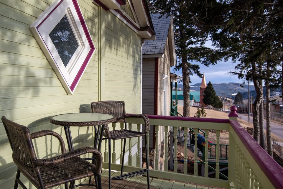 There is outdoor seating overlooking the mountains and city in front, and also a patio in back with private grill and seating area