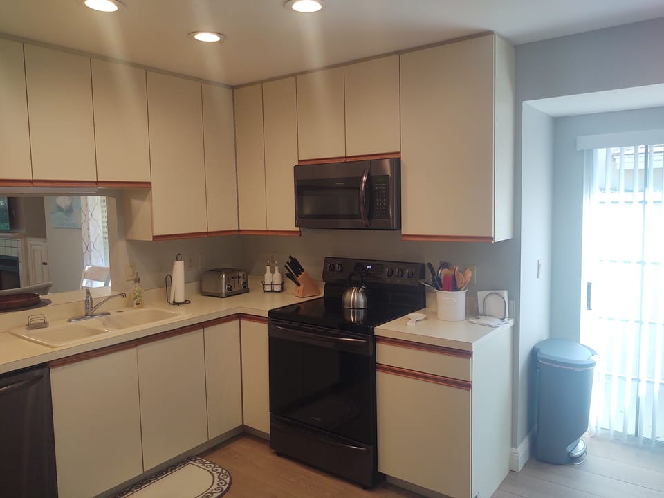 Large kitchen with all newer appliances. Sliders to private enclave where the grill is located.