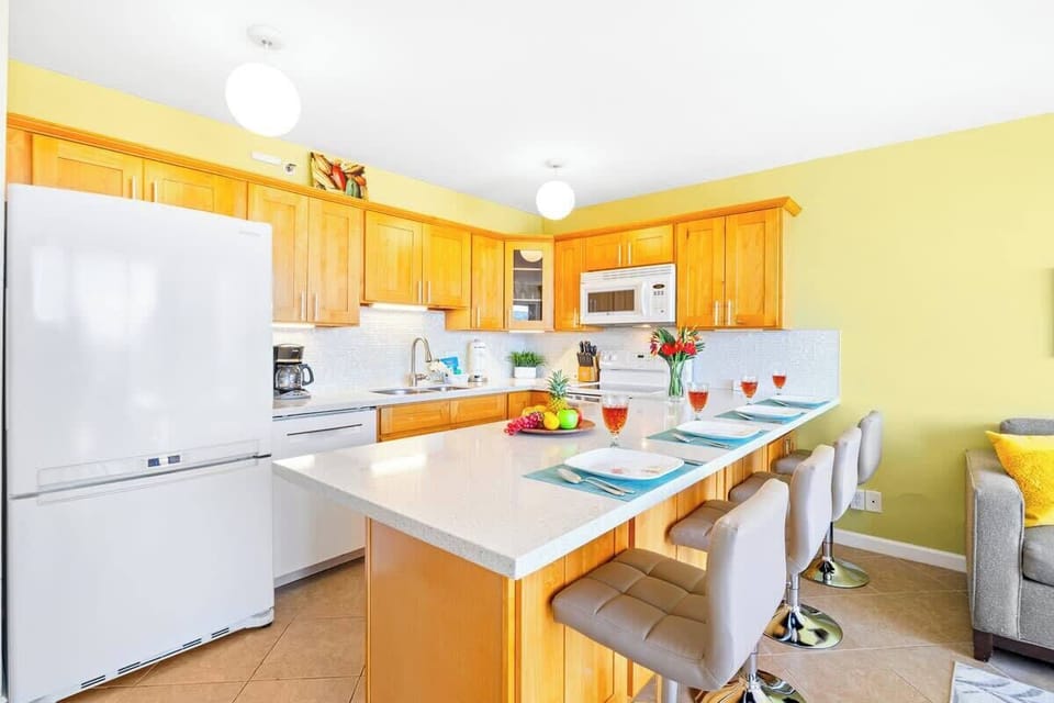 The dining area has a countertop with four bar stools.