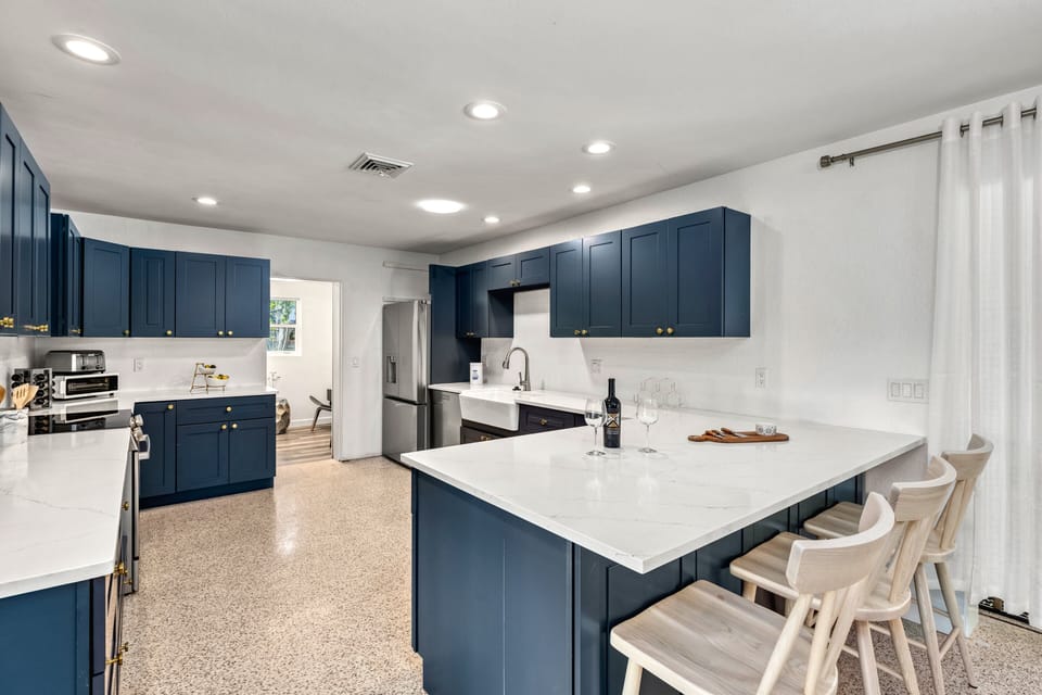 A central island with bar seating welcomes casual meals, morning coffee, or happy hour mingling.