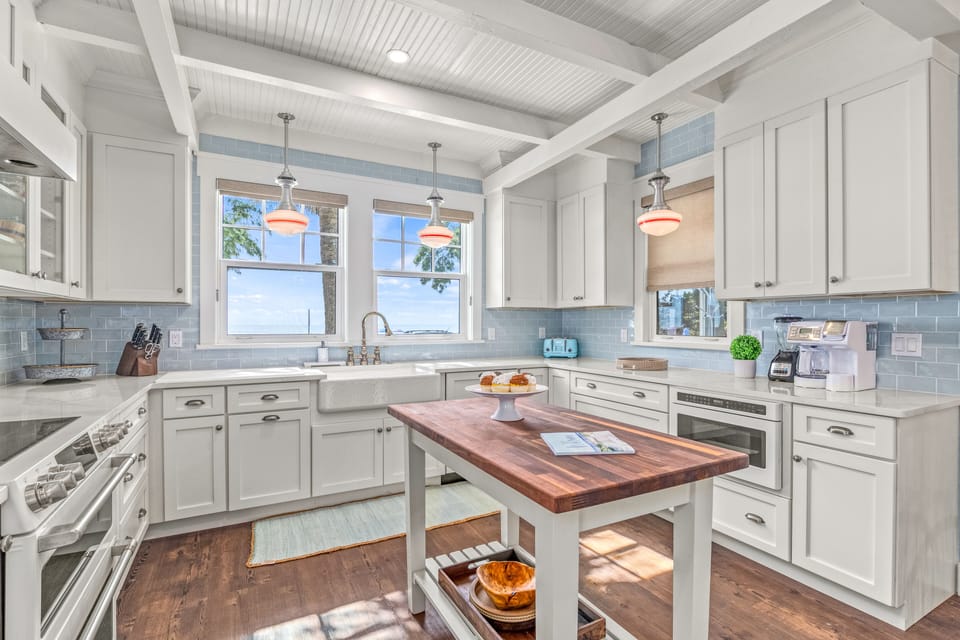 Kitchen with country work table and state of the art appliances.