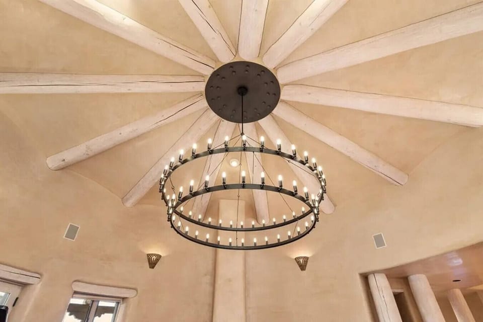 Unique rod-iron chandelier and New Mexico style ceiling design