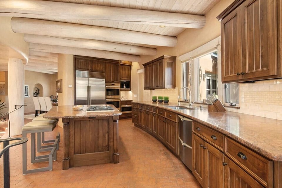 Spacious gourmet kitchen with island, including Wolf gas cooktop and countertop seating