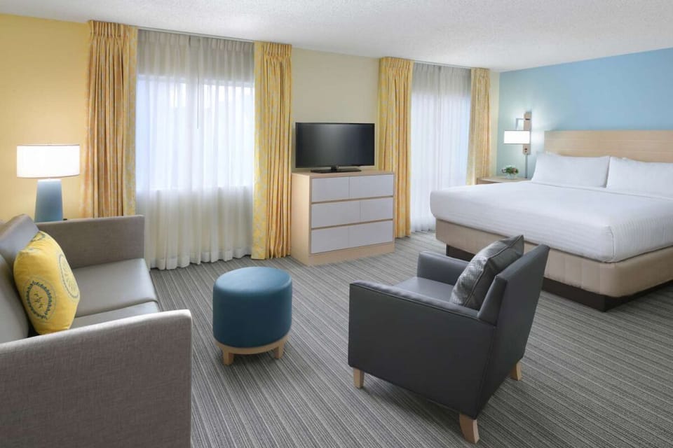 Relax in a bright king room with cozy seating area.