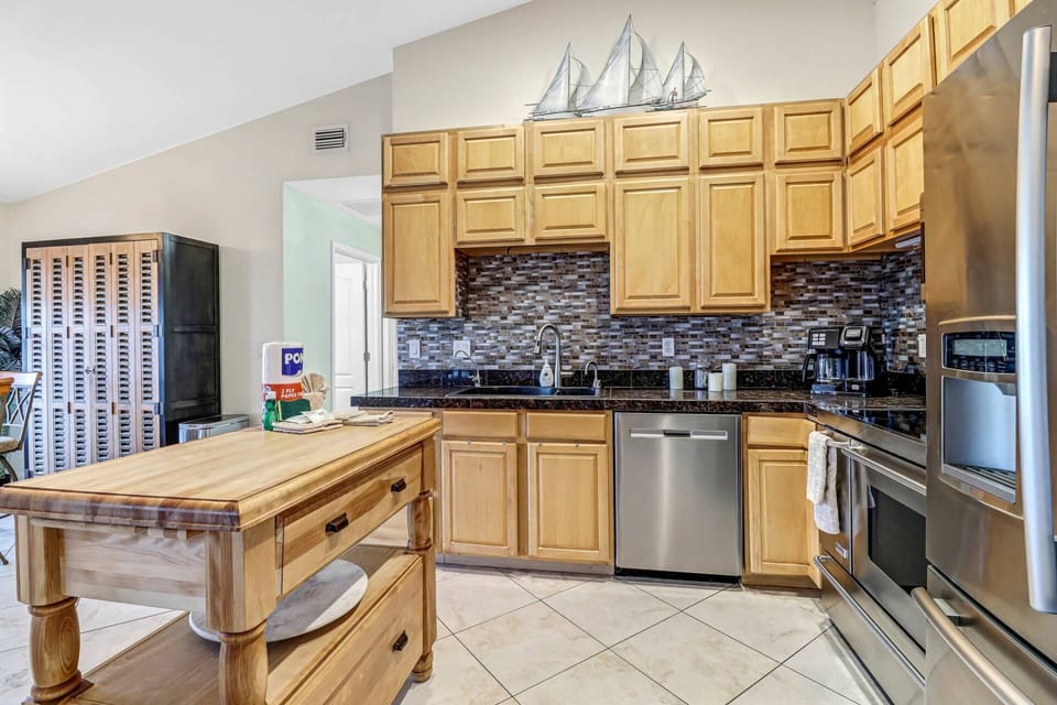 A butcher block island helps define the kitchen space and provides a great spot for serving family-style meals.